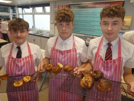three haygrove students proudly displaying their yorkshire puddings